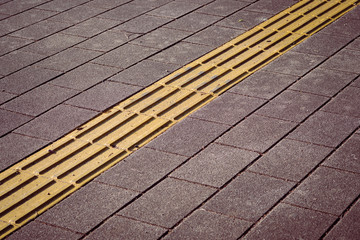 道路に設置された黄色い線状の点字ブロック