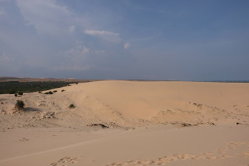 Fototapeta na wymiar woman tourist and relaxing at white sand dunes