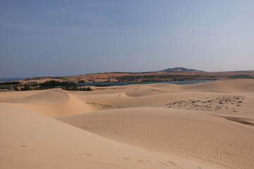 beautiful white sand dune on sunset background