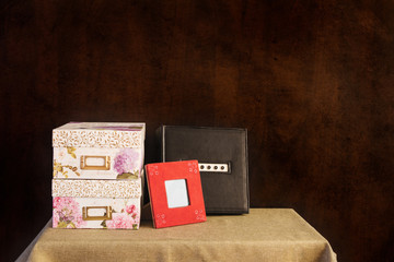 Memory boxes; photo album; photo frame displayed on a table; collection of memories in photographs