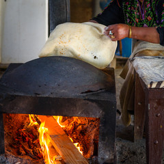 Close up of old Arab woman hands kneading fresh dough for Taboon bread or Lafah is a Middle Eastern...