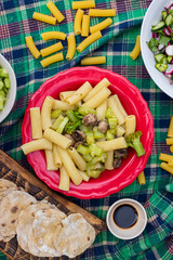Pasta with vegetables, Italian macaroni on plate with soy sauce and fresh salad. Vegetarian vegan healthy food. Top above view