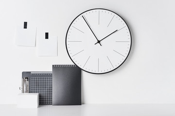 Office supplies, sticky and round clock on white