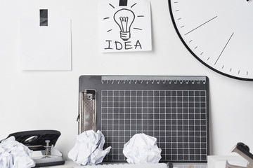 Office supplies and wall clock on white