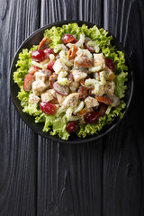 Sonoma salad with chicken breast, celery, pecans and grapes seasoned with spicy sauce close-up on a...