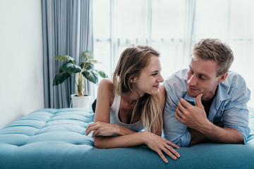romantic couple enjoy chatting while lying on the bed together