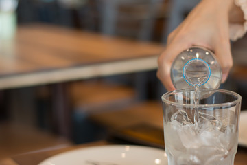 Clean drinking water from safe plastic bottles, Pouring into a glass,