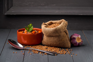 Bowl of tasty buckwheat porridge on table.