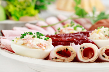 Stuffed egg and sliced ham on the table.