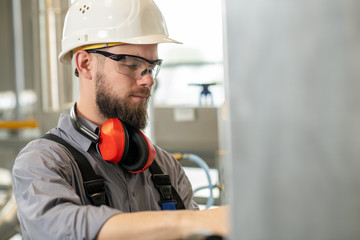 worker with helmet ,ear protector and goggles