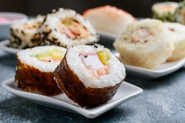 Sushi set on grey stone background.