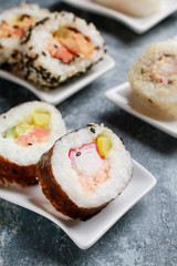 Sushi set on grey stone background.