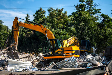 Stones, destroyed buildings, building. Demolition. A pile of stones. Crane
