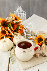 Cup of tea and beautiful autumn floral decorations on the table.