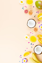 Summer tropical fruits frame on coral color background