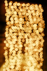 Gold glittering christmas lights. Blurred abstract background.