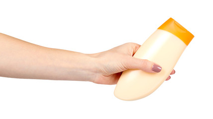 Hand with plastic cosmetic bottle, shampoo and soap gel.