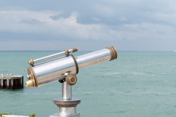 Sightseeing Vintage coin operated binocular overlooking for viewer ocean sea Beach