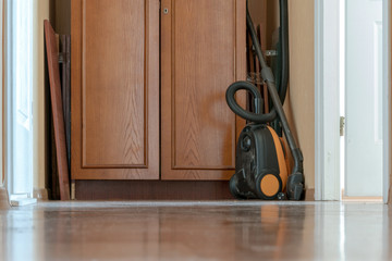 vacuum cleaner on the floor in a dirty room