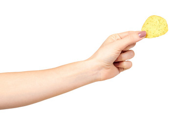 Hand with golden color potato chips, crunchy and wavy.