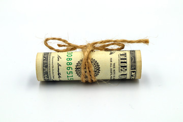 Picture of a dollar banknote with a rope tied and rolled in a circle on the isolated background