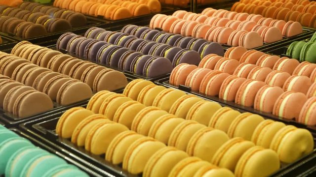 Trays with colorful macaroons. Metal trays with delicious colorful macaroons placed on stall in cafe.