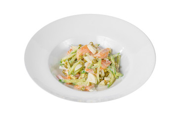 Russian salad with fish salmon, cucumber, peas, eggs, mayonnaise on plate, white isolated background, side view