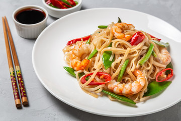 Asian dish of fried rice noodles with shrimp and vegetables