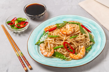 Asian dish of fried rice noodles with shrimp and vegetables