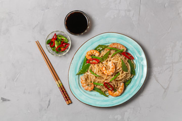 Asian dish of fried rice noodles with shrimp and vegetables. The view from the top. Copy-space.