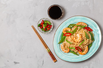 Asian dish of fried rice noodles with shrimp and vegetables. The view from the top. Copy-space.