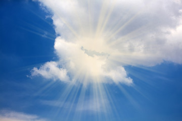 blue sky with a cloud and light ray