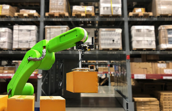 Industrial Robot Holding A Box Operating A Robot Machine With A Control Panel On Stock Shelves Background