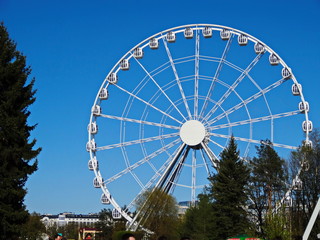 Ferris wheel on a background of blue sky