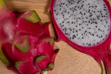 Cut Dragon Fruit. On a stand made of wood.
