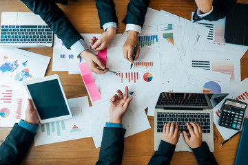 Businesspeople analyzing investment graph meeting brainstorming and discussing plan in meeting...