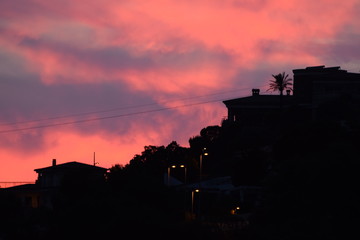 Silhouette of a Spanish provincial town against a pink-blue sunset sky.