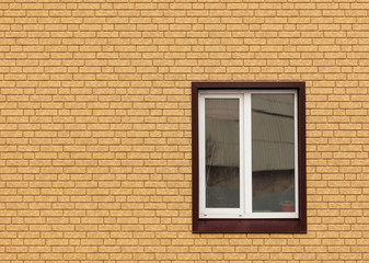 Fototapeta na wymiar The window in the wall of the house of yellow brick
