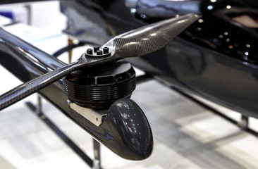 Selective focus on black drone propeller UAV rotor.