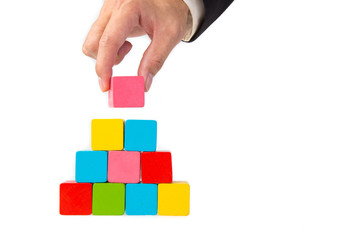 Obraz premium hand stacking a color wooden block