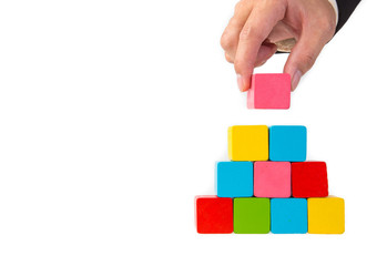 Obraz premium hand stacking a color wooden block