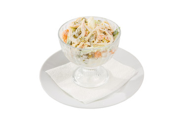 Russian salad with ham and squid, cucumber, peas, eggs, mayonnaise on plate in a tall bowl, white isolated background, side view
