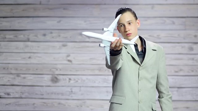 Young businessman playing with a toy plane