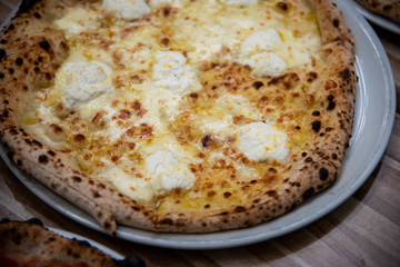 Four cheese pizza (Quattro Formaggio) on wooden table, Italian cuisine in Vancouver, Canada