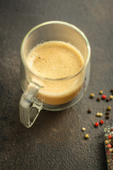 coffee with milk (cappuccino or latte) flavored drink in a transparent cup. food background. top