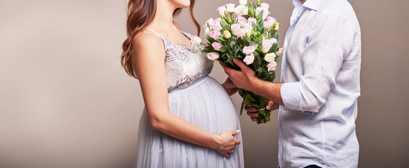 pregnant couple in a frame without a face