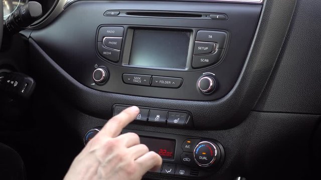 Hand finger pressing pushing button on car disable stabilization: Traction Control System off.