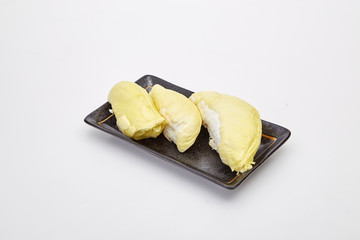 Ripe yellow flesh of Durian on black plate