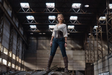 Fototapeta na wymiar girl in a steampunk costume at an abandoned factory.