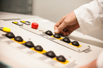 Hand pushing the button on the control panel